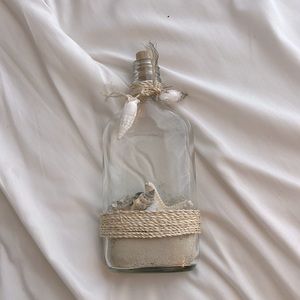 boho glass bottle with sand and shells